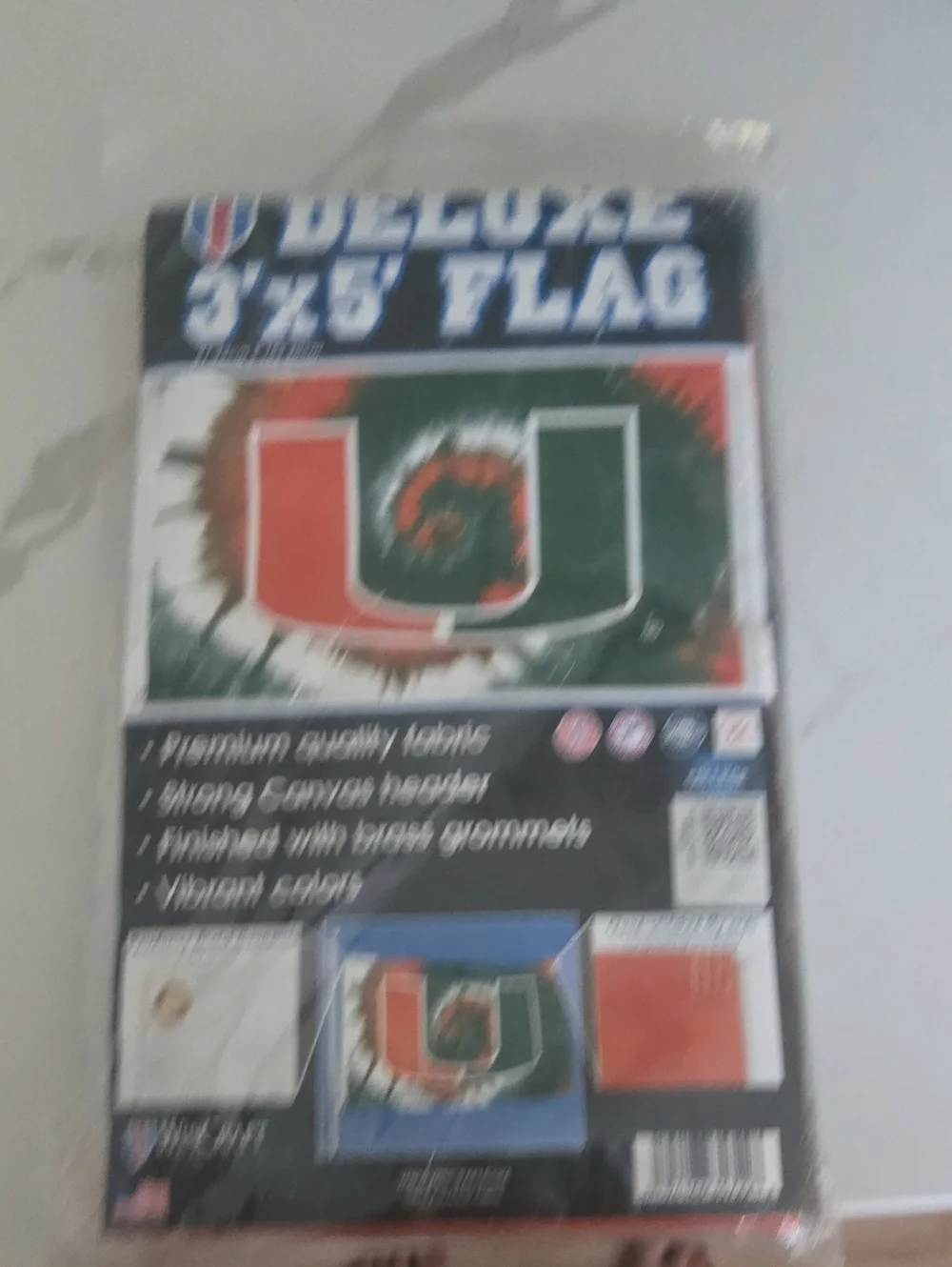 The University Of Miami Wincraft Tie-Dye U Logo Flag in Orange and Green